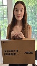 young girl holding a laptop box