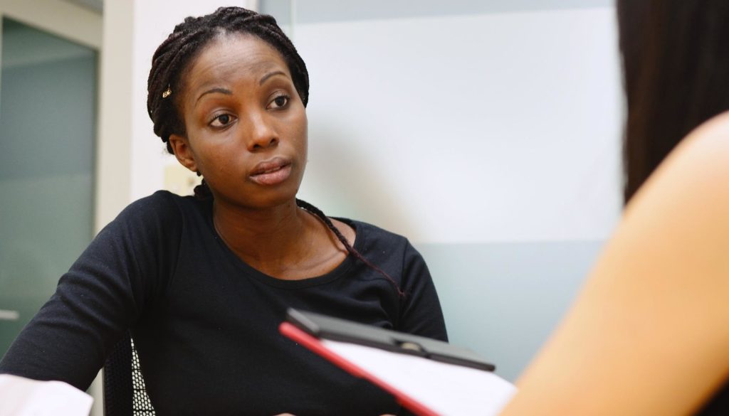 A woman talking to a clinician