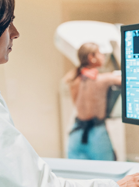 Doctor examining a computer screen with a mammography scan