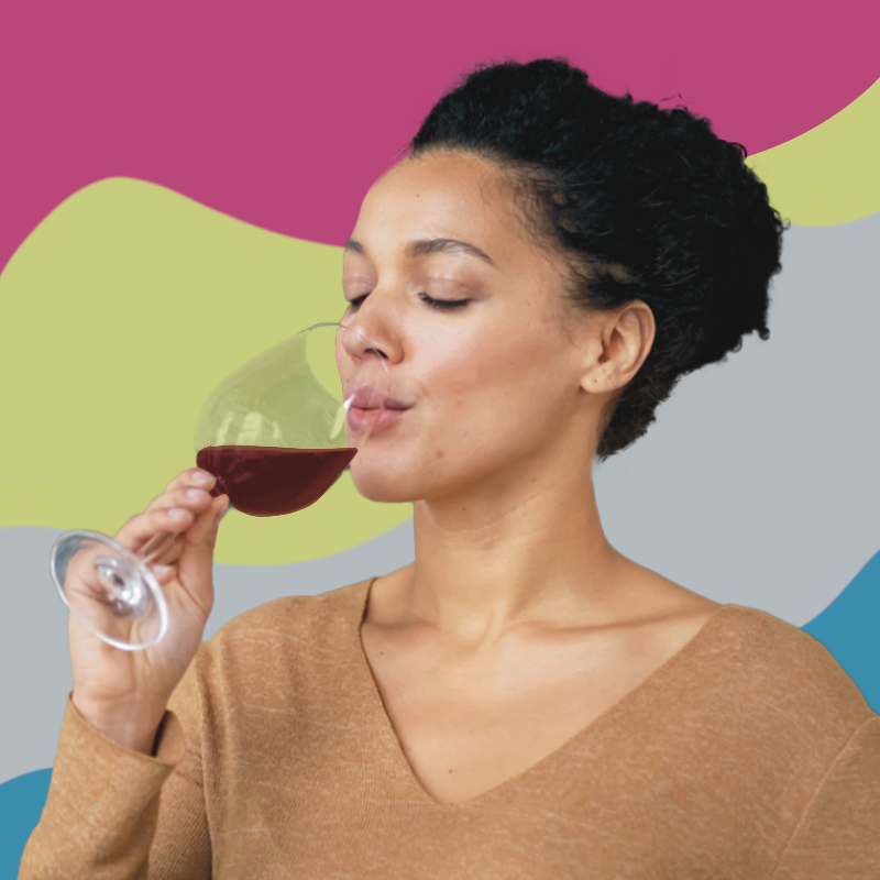 A women drinking red wine out of a wine glass