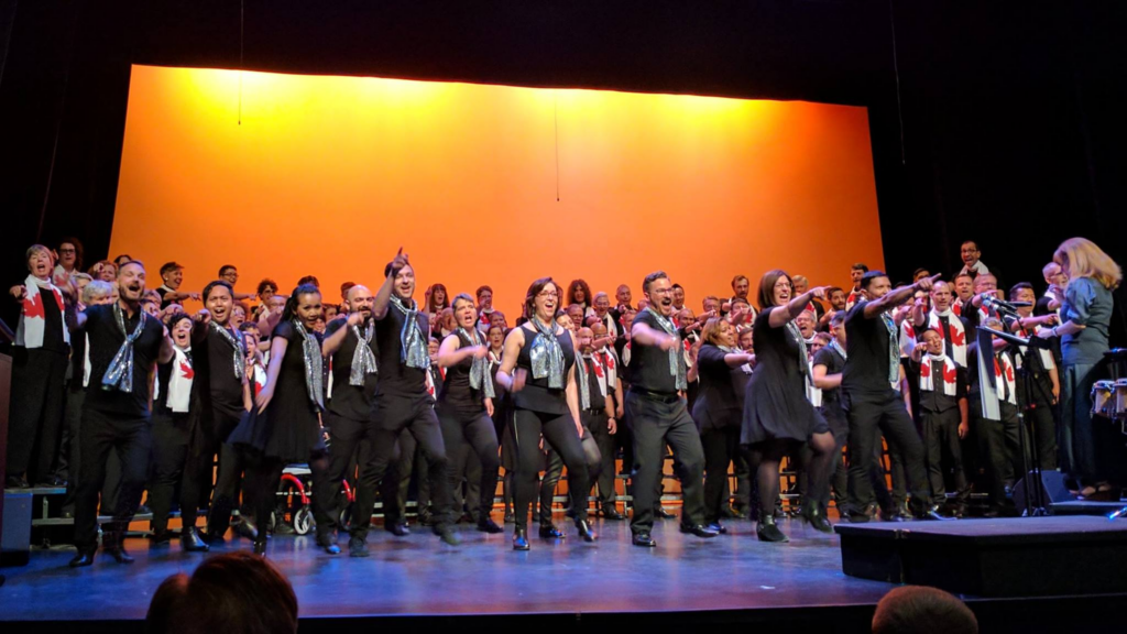 Image of  Singing Out Choir on stage performing. 